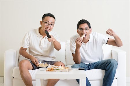 Friendship, technology and home concept. Smiling male friends with remote control and junk food at home. Stock Photo - Budget Royalty-Free & Subscription, Code: 400-08494552