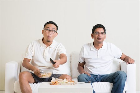 Men sitting on couch watching television, Asian people friendship at home. Stock Photo - Budget Royalty-Free & Subscription, Code: 400-08494553