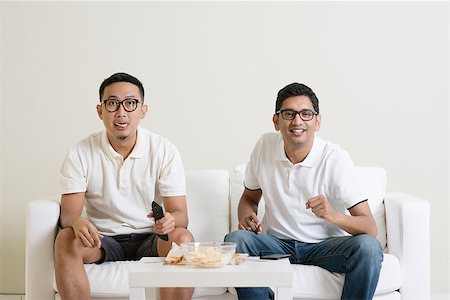 Friendship, sports and entertainment concept. Male friends watching live sports show together on tv at home. Stock Photo - Budget Royalty-Free & Subscription, Code: 400-08494561