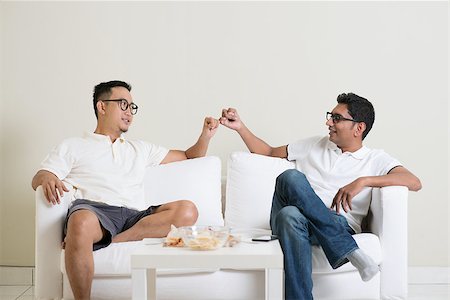 Friends sitting on sofa and giving hand promise at home. Multiracial people friendship. Stock Photo - Budget Royalty-Free & Subscription, Code: 400-08494577