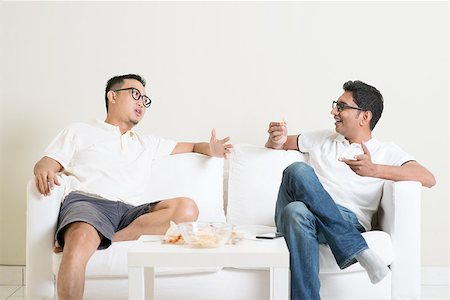 Men talk concept. Two young male friend sitting on sofa and chatting at home. Multiracial people friendship. Stock Photo - Budget Royalty-Free & Subscription, Code: 400-08494573