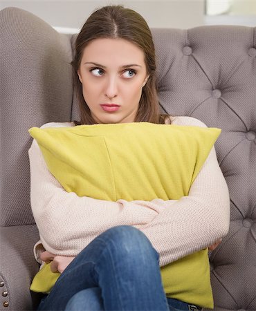 simsearch:400-04124768,k - Depressed teenager talk with psychologist about her problems. Pretty brunette holding pillow infront on her. Stock Photo - Budget Royalty-Free & Subscription, Code: 400-08494753