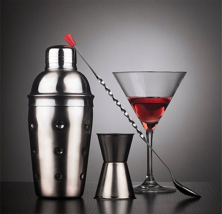 Cocktail tools with shaker, spoon and a glass filled with red liquid,  square composition Stock Photo - Budget Royalty-Free & Subscription, Code: 400-08495005