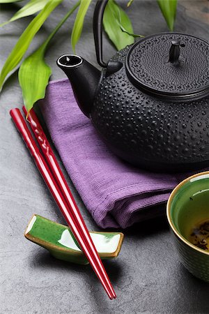 Asian sushi chopsticks, tea bowl and teapot over stone table Stock Photo - Budget Royalty-Free & Subscription, Code: 400-08495335