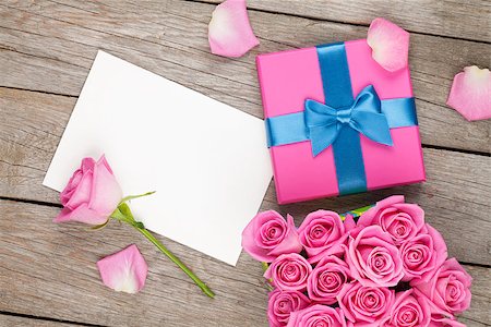 simsearch:400-08110734,k - Valentines day greeting card or photo frame and gift box full of pink roses over wooden table. Top view Stock Photo - Budget Royalty-Free & Subscription, Code: 400-08495345