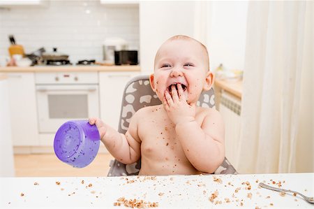 Little baby eating. Happy messy eater Fotografie stock - Microstock e Abbonamento, Codice: 400-08495363