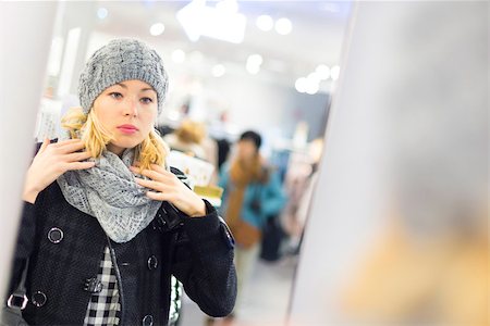 Woman shopping clothes. Shopper looking at clothing indoors in store. Beautiful blonde caucasian female model. Stock Photo - Budget Royalty-Free & Subscription, Code: 400-08495378