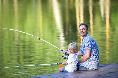 father and son fishing dock lake - Dad and son fishing outdoors Stock Photo - Budget Royalty-Free & Subscription, Code: 400-08495570