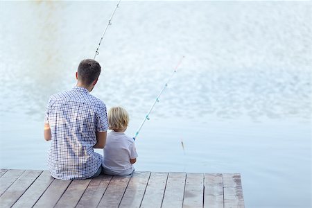 father and son fishing dock lake - Dad and son fishing on a pier Stock Photo - Budget Royalty-Free & Subscription, Code: 400-08495585
