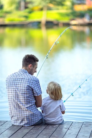 father and son fishing dock lake - Dad and son fishing on a pier Stock Photo - Budget Royalty-Free & Subscription, Code: 400-08495586