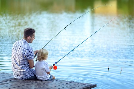 father and son fishing dock lake - Dad and son fishing at lake Stock Photo - Budget Royalty-Free & Subscription, Code: 400-08495587