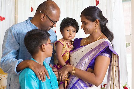 Traditional India family portrait. Indian parents and children in a blessing ceremony. Stock Photo - Budget Royalty-Free & Subscription, Code: 400-08495847