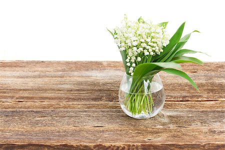 simsearch:689-03124006,k - Lilly of valley flowers in glass on wooden table border isolated on white background Photographie de stock - Aubaine LD & Abonnement, Code: 400-08496014