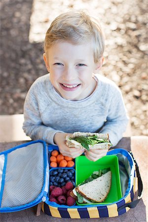 cheerful schoolboy eating healthy lunch outdoor Stock Photo - Budget Royalty-Free & Subscription, Code: 400-08496045