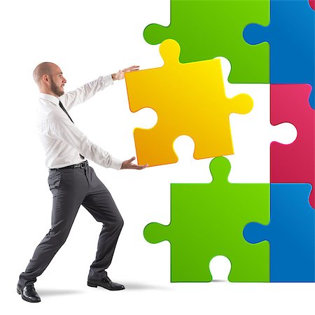 simsearch:400-08668633,k - Businessman complete a puzzle inserting last piece Stock Photo - Budget Royalty-Free & Subscription, Code: 400-08496167