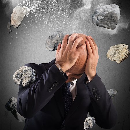 Man protects himself from a boulders rain Stock Photo - Budget Royalty-Free & Subscription, Code: 400-08496161