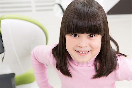 simsearch:400-04340942,k - Portrait of happy smiling little girl at dentist's office. Brunette lady looking at the camera while sitting at the dentist's chair. Stock Photo - Budget Royalty-Free & Subscription, Code: 400-08496325