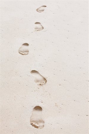 Five human footprints leading towards the viewer. Copyspace for text on righthand side Stock Photo - Budget Royalty-Free & Subscription, Code: 400-08496724