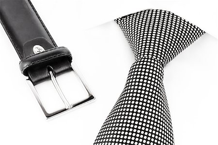 black and white spotted tie knotted Windsor and leather belt Stockbilder - Microstock & Abonnement, Bildnummer: 400-08497159