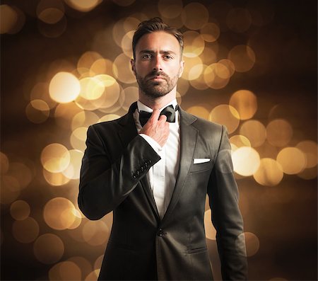 simsearch:400-06795988,k - Elegant man with papillon on golden background Foto de stock - Super Valor sin royalties y Suscripción, Código: 400-08497234