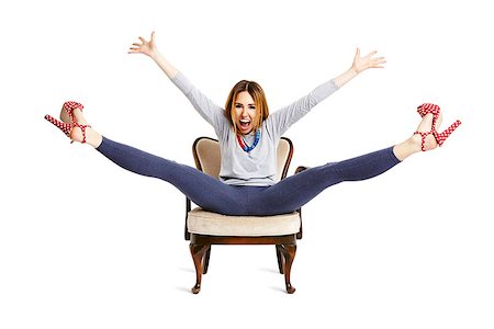Enjoying a girl raises her arms and legs up. Isolated on white background. Stock Photo - Budget Royalty-Free & Subscription, Code: 400-08497255