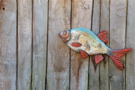 Fish made of wood on wooden boards, background Foto de stock - Super Valor sin royalties y Suscripción, Código: 400-08497357