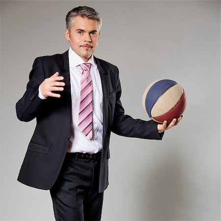 Senior businessman getting ready to shoot a basketball Stock Photo - Budget Royalty-Free & Subscription, Code: 400-08497916