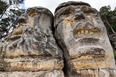 Heads of Devils are about 9 m high rock sculptures of giant heads carved into the sandstone cliffs in the pine forest above the village Zelizy in the district Melnik, Czech republic. It is the work of sculptor Vaclav Levy, who created in the period 1841-1846. Stock Photo - Budget Royalty-Free & Subscription, Code: 400-08498312
