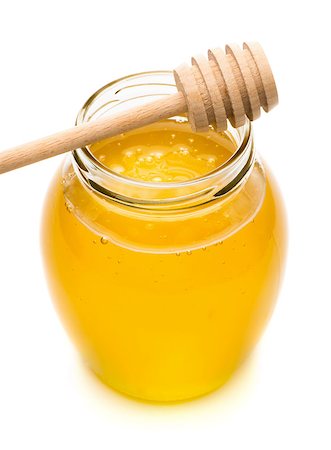 simsearch:400-04865454,k - Natural honey in a glass jar, spoon for honey closeup isolated on white background Stockbilder - Microstock & Abonnement, Bildnummer: 400-08498459