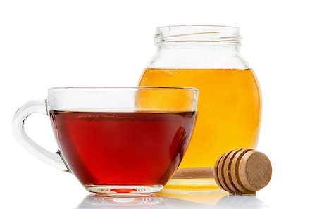 simsearch:400-04691031,k - Black tea in a transparent glass cup honey pot and spoon for honey closeup isolated on a white background Photographie de stock - Aubaine LD & Abonnement, Code: 400-08498461