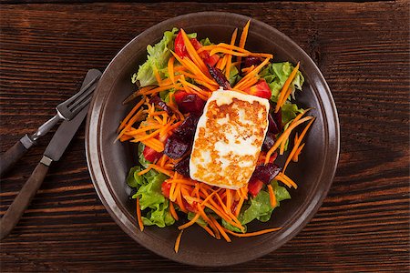 Grilled halloumi cheese with colorful fresh salad on plate on wooden table, top view. Culinary delicious vegetarian eating, mediterranean style. Stock Photo - Budget Royalty-Free & Subscription, Code: 400-08499203