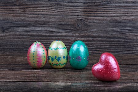 easter eggs in a dark color - Three Easter eggs with red heart on wooden backgorund Stock Photo - Budget Royalty-Free & Subscription, Code: 400-08499788