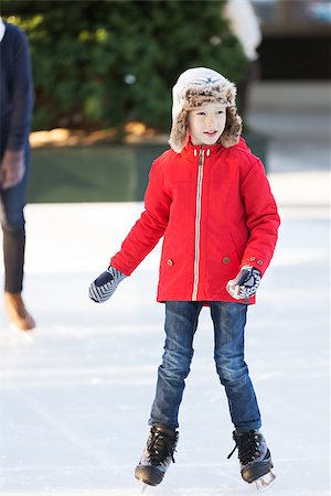simsearch:400-08318063,k - little boy learning ice skating and his mother watching and cheering up at outdoor skating rink, having winter vacation fun Photographie de stock - Aubaine LD & Abonnement, Code: 400-08492556