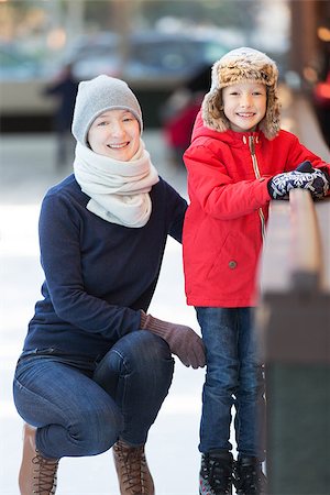 simsearch:400-08318057,k - little boy and his mother ice skating together at outdoor skating rink, having winter vacation fun Stock Photo - Budget Royalty-Free & Subscription, Code: 400-08492550