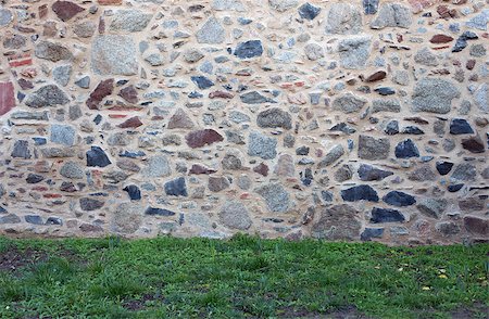 Old stone wall with different size of rock, in the foreground grass Foto de stock - Super Valor sin royalties y Suscripción, Código: 400-08492694