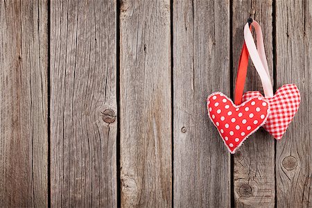 Two Valentines day hearts on rustic wooden wall with copy space Stock Photo - Budget Royalty-Free & Subscription, Code: 400-08493442