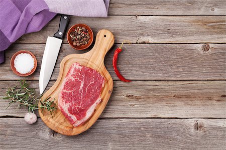 simsearch:400-06088770,k - Raw beef steak and spices on wooden table. Top view with copy space Stock Photo - Budget Royalty-Free & Subscription, Code: 400-08493456