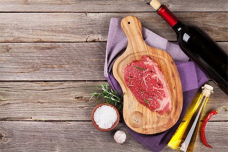 simsearch:400-06088770,k - Raw beef steak with spices and herbs on wooden table. Top view with copy space Stock Photo - Budget Royalty-Free & Subscription, Code: 400-08493464
