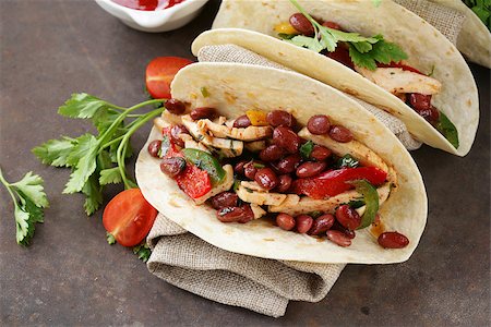 simsearch:400-08052263,k - Mexican food is tacos on wheat tortilla with chicken and beans Photographie de stock - Aubaine LD & Abonnement, Code: 400-08504274