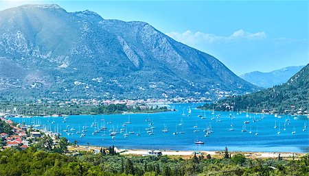 simsearch:400-05244057,k - Many sailing vessels in bay. Hazy summer Lefkada coast panorama (Nydri, Greece, Ionian Sea). Stockbilder - Microstock & Abonnement, Bildnummer: 400-08505143