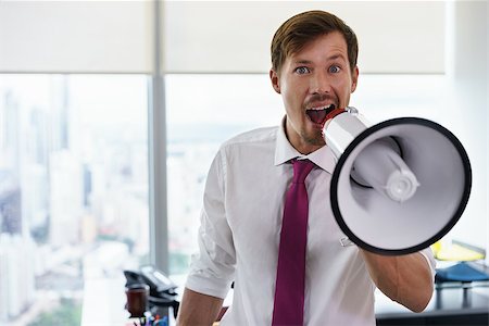 simsearch:6109-06195330,k - Young executive office worker holding megaphone and speaking at camera with confidence and funny expression. Copy space Photographie de stock - Aubaine LD & Abonnement, Code: 400-08505931
