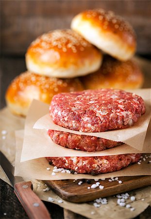 steak roll bun - Raw ground beef meat steak cutlets and burger buns on  wooden background, ready for cooking Stock Photo - Budget Royalty-Free & Subscription, Code: 400-08506442