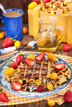 simsearch:400-07917638,k - Belgian pumpkin waffles with fresh strawberry, kumquat, honey and cup of coffee Stock Photo - Budget Royalty-Free & Subscription, Code: 400-08506455