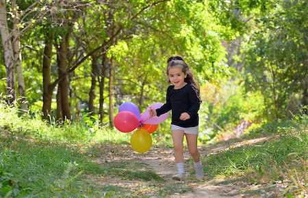 Little girl playing in autumn park with balloons Stock Photo - Budget Royalty-Free & Subscription, Code: 400-08506791