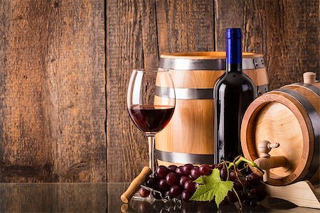 simsearch:400-08110621,k - Glass of red wine with dark bottle barrel grapes and wooden background Stock Photo - Budget Royalty-Free & Subscription, Code: 400-08506800