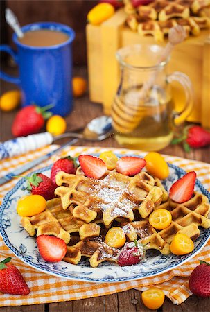 simsearch:400-07917638,k - Belgian pumpkin waffles with fresh strawberry, kumquat, honey and cup of coffee Stock Photo - Budget Royalty-Free & Subscription, Code: 400-08508637