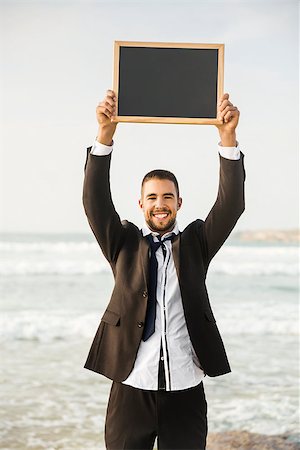 Business young man in outdoor holding a chalkboard Stock Photo - Budget Royalty-Free & Subscription, Code: 400-08500581