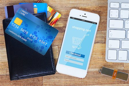 smartphone payment - desk with internet store page on mobile  phone and wallet with plastic cards Stock Photo - Budget Royalty-Free & Subscription, Code: 400-08501604