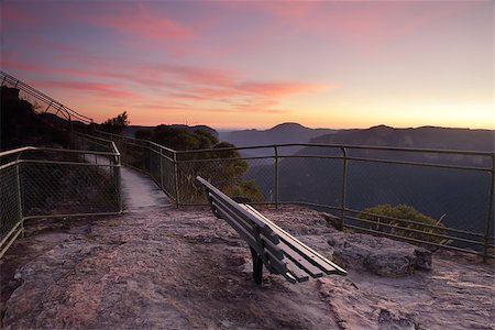 Spectacular dawn skies overhead with views from Pulpit Rock, Blackheath, stunning scenery and views overlooking the Grose Valley with Mount Baniks directly ahead in the far distance. This seat awaits you! Stock Photo - Budget Royalty-Free & Subscription, Code: 400-08502743