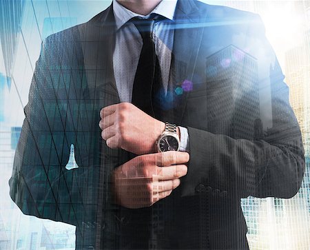 simsearch:400-08812456,k - Elegant businessman with clock on skyscrapers background Stock Photo - Budget Royalty-Free & Subscription, Code: 400-08503207